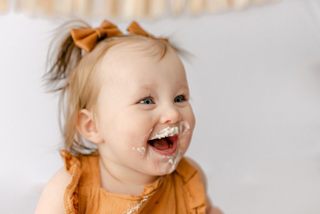 Icing on baby's face from 1st Birthday Cake Smash 