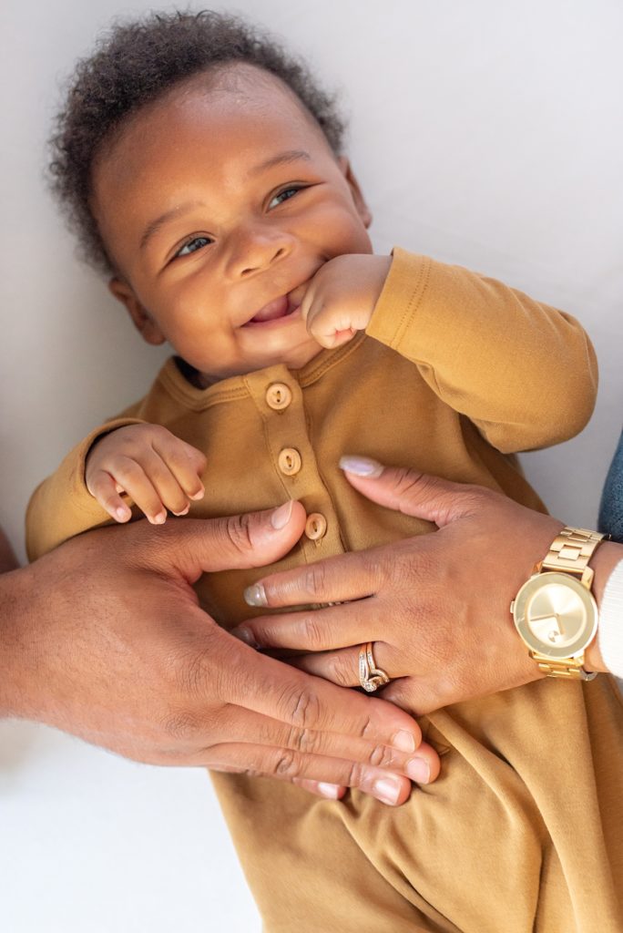 parents holding baby