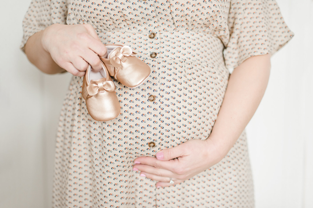 Baby bump and baby shoes  | 5 Tips to Prepare for Maternity Photos
